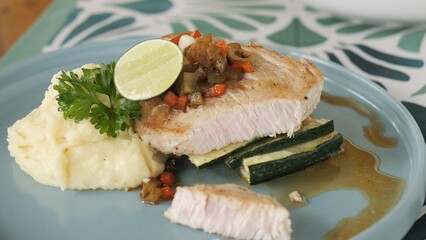 Diet menu with low-calorie grilled fish fillet and zucchini served with creamy mashed potatoes Closeup of fresh zucchini garnish zucchini slices and healthy fish perfect for culinary food projects