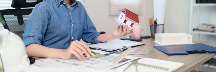 Asian Adult Architect Hands Design House Model Blueprint Planning House Construction and Real...