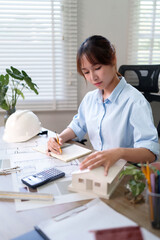 Young Asian Woman Architect Designs Building Model in Office - Architect Drawing Plans and Inspecting - Best Architect Career and Skills 