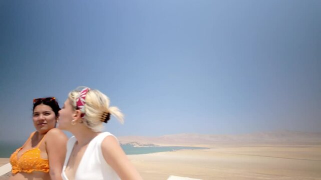 Multi racial friends enjoying scenic view in paracas national reserve