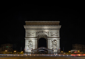 Fototapeta premium The Nightscape view of Famous Arc de Triomphe (Triumphal Arch) at the city center of Paris and traffic trails in Chaps Elysees. Symbol of the glory and historical heritage, Iconic architectural.