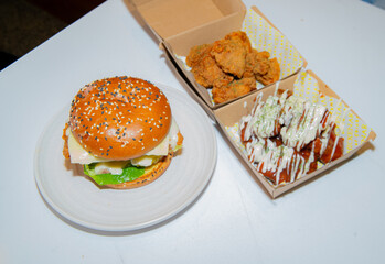 Deep-fried boneless Korean chicken burger with sweet buns. Crispy outside, juicy and succulent inside, smelling delicious.
