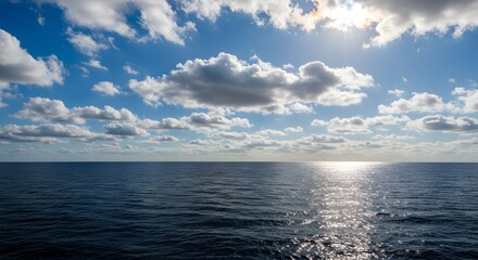 Fototapeta premium Serene Ocean Vista: Sunlit Horizon with Puffy Cumulus Clouds