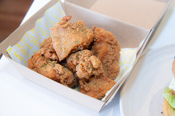 Close-up of a stack of deep-fried boneless chicken pieces. Crispy outside, juicy and succulent inside, smelling delicious.