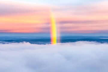 Majestic Rainbow Arcing Over Misty Mountain Landscape at Sunrise