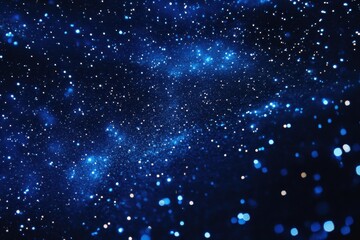 Obraz premium Deep space filled with glittering stardust. A mesmerizing display of celestial bodies and cosmic dust. Dark blue hues with scattered, shimmering particles