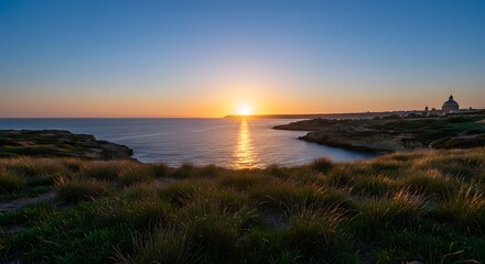 Ocean Sunset Over Rocky Coastline with Grass Foreground