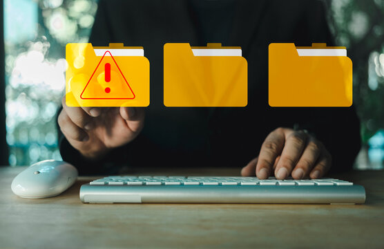 Hand touch a folder with a cybersecurity warning. Warning symbol for malware, virus, or spyware. Computer network threats. Cybersecurity alert with digital file folder.
