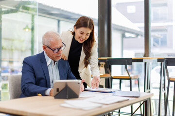 Team of confident business people point to graphs and charts to analyze market data, balance sheet, account, net profit to plan new sales strategies to increase production capacity.	
