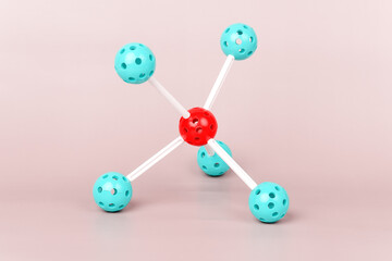 Molecular structure model with a red center and turquoise spheres