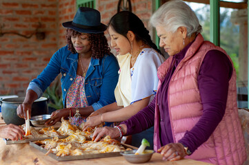 Women preparing traditional food in rustic kitchen