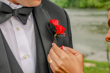 Pinning on a boutonniere 