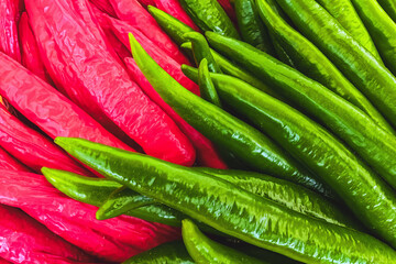 Full frame many green and red chilies for cooking Asian food. Herb and food ingredient. Chilli pepper. Pile of chillies spicy background texture. Fresh Thai chili pepper for spicy ingredient in food.