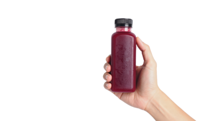 hand holding cold pressed juice bottle on white background png