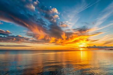 Obraz premium Fiery Sunset Sky over Calm Ocean Dramatic Colors and Golden Reflections