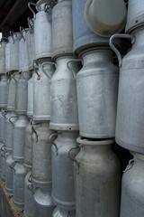 Old milk churns stacked up high