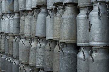 Old milk churns stacked up high