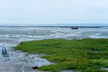 Saint-Vaast-la-Hougue France - 21 September 2023 - Tractors working on the oyster fields just...