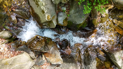 Obraz premium Valley for Summer Vacation ,Slow Motion ,Clear Stream flowing over rocks and rocks ,Rich Valley in slow motion ,Crystal clear water spills over rocks ,Silent natural scene