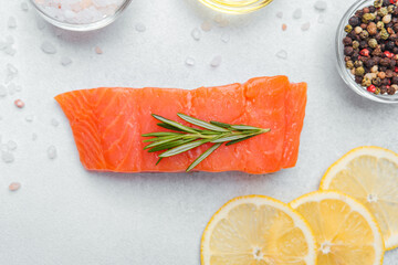Fresh salmon fillet prepared with herbs and lemon slices for cooking