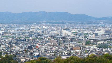 Kyoto, Japan – April 15, 2024: Panoramic view of Kyoto city and surrounding mountains from the summit of Mount Inari, along the path of Fushimi Inari Taisha, one of Japan’s most iconic landmarks.