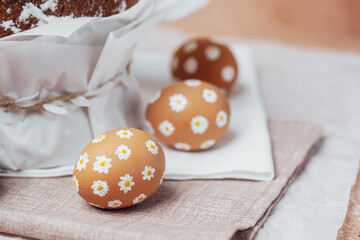 Traditional Easter cake with hand-painted daisy eggs on fabric. Homemade festive baked goods and...
