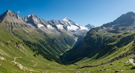 Fototapeta premium Hiking Path Winding Through Green Mountain Valley on Sunny Day