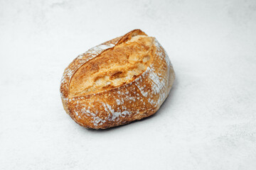 Freshly baked sourdough bread on a kitchen surface in natural light