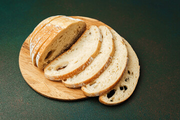 Freshly sliced artisan bread on a wooden cutting board in natural light