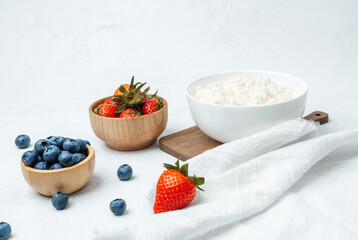 Delicious bowl of cottage cheese with fresh strawberries and blueberries