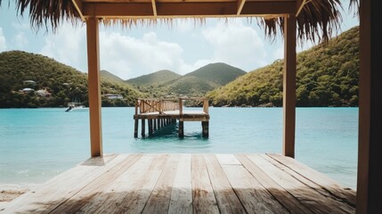 Fototapeta premium Tranquil tropical getaway. Pier extending into turquoise water, framed by lush green hills