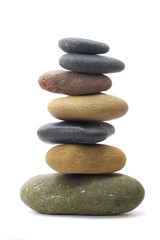 Natural stacked smooth stones in a balanced arrangement isolated on white background