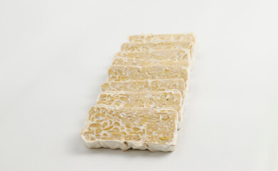 slices of tempe indonesian traditional food on white background. food for diet. healthy food tempe indonesia