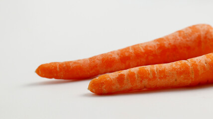 fresh carrots on a plate isolated in white background.  healthy food for kids and vegan. fresh vegetables for cooking.