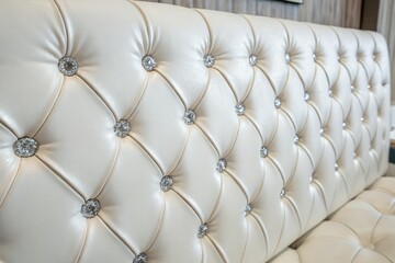 Close-Up of Luxurious White Upholstery with Crystal Buttons