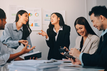 Team of financial advisory services. Asian advisor showing plan of investment to clients in the consultancy office..