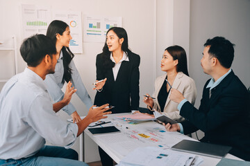 Team of financial advisory services. Asian advisor showing plan of investment to clients in the consultancy office..