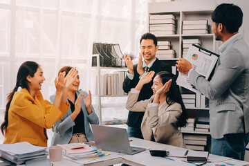 Group of Young Asian business team creative businesspeople coworker in office Happy to be successful partnership teamwork celebrating achievement and success concept.
