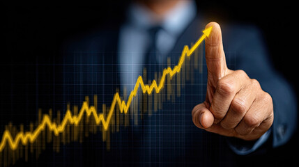 Businessman pointing at a rising graph, symbolizing growth and success.