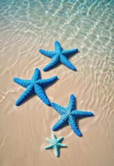 Three vibrant blue starfish on sandy beach, shallow water (1)