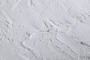 White acrylic textured plaster. Drops, lines, arrows, cracks in close-up. Drawing with a spatula