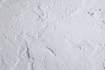 White acrylic textured plaster. Drops, lines, arrows, cracks in close-up. Drawing with a spatula