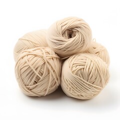 Beige yarn balls with crafting supplies.