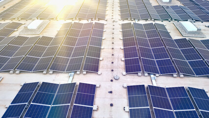 A bird's-eye view of a vast rooftop adorned with rows of solar panels, symbolizing eco-friendly...