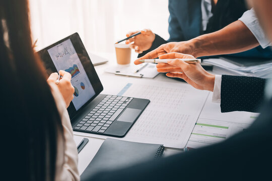 Team of financial advisory services. Asian advisor showing plan of investment to clients in the consultancy office..