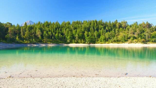 Alpine lake Urisee in Tirol with vibrant turquoise water, serene mountain backdrop, and untouched natural surroundings
