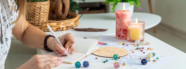 Woman astrologer draws a natal chart. Selective focus