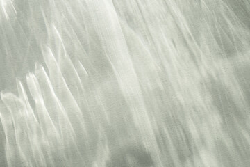 Obraz premium Abstract shadows background from pouring sunlight top view. Natural caustic background from light glare and shine reflection effects for product presentation.