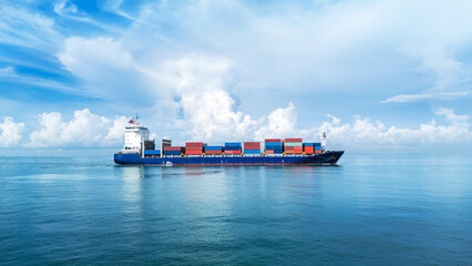 Large container cargo ship sailing across calm blue sea under bright sky, loaded with colorful...