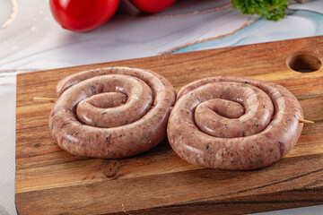 Raw meat pork and beef swirl sausages